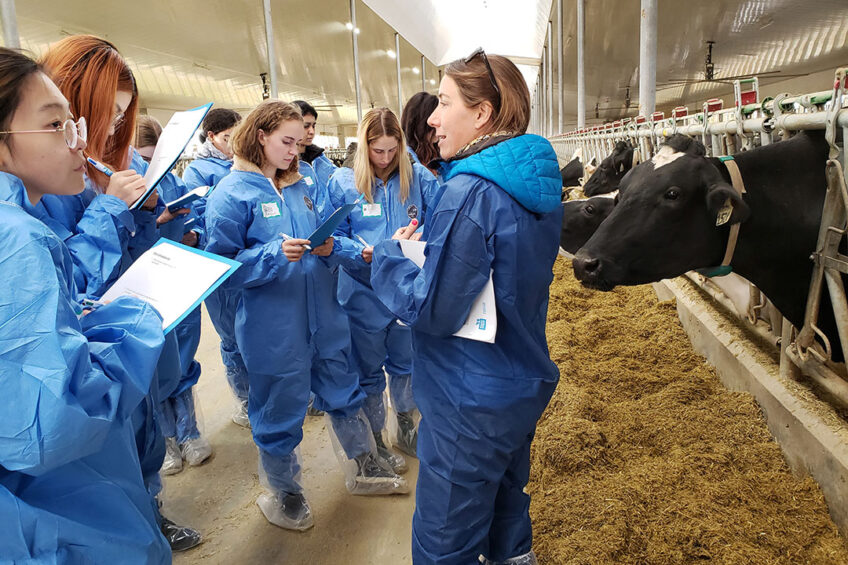 Visitors from a post-secondary institution in Canada wear protective clothing and shoe covers while touring a dairy farm to learn about proAction. Photo: Dairy Farmers of Canada