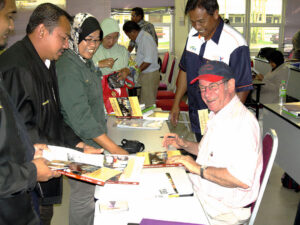 Dr Moran signing one of his books in Malaysia.