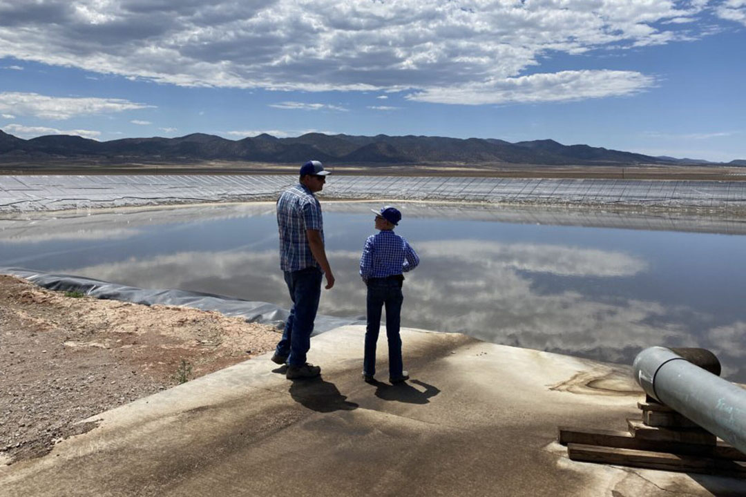 Operations manager Kimball and his  son at the lagoon, where the waste water from the milking parlour is collected and pumped out onto the fields as fertiliser. Photo: Aage Krogsdam