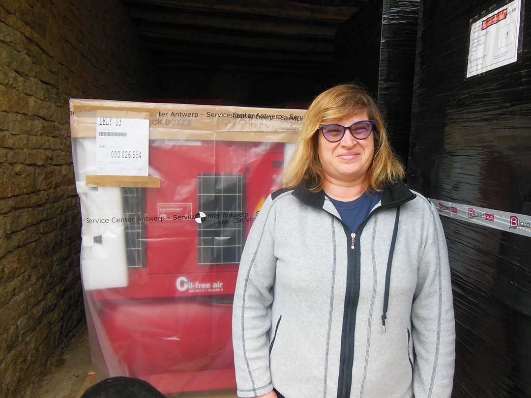 Nathalie Mairet: “I like to meet colleagues and milk cooperatives and dairy manufacturers.” Here she she is in front of unpacked just arrived milking robot. Photo: Philippe Caldier